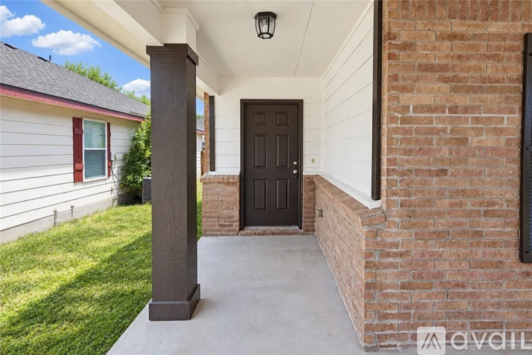 A house with a black door and a grey pillar.