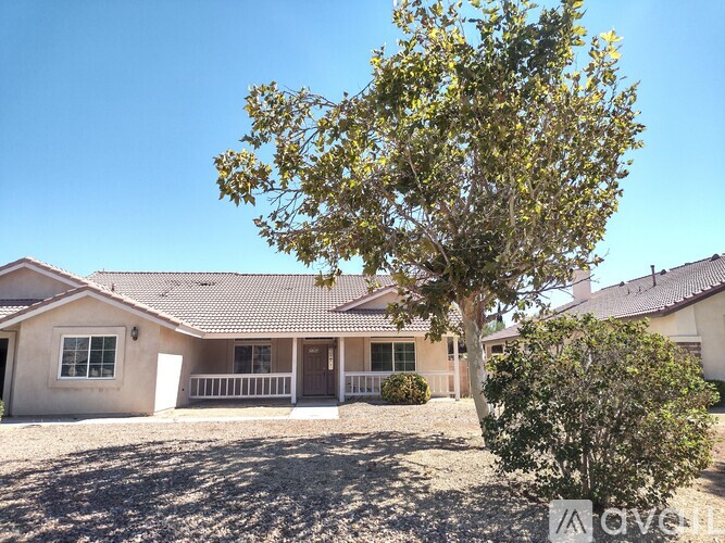 A house with a tree in front of it.