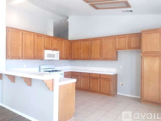 A kitchen with wooden cabinets and a white countertop.