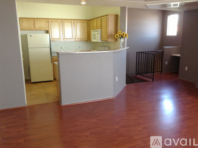 A kitchen with wooden cabinets and a white refrigerator.