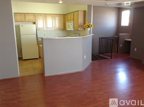 A kitchen with wooden cabinets and a white refrigerator.