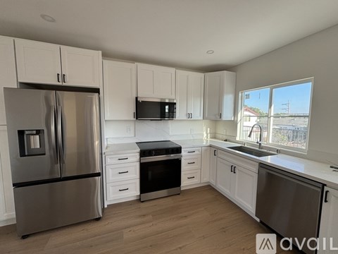 A kitchen with white cabinets and stainless steel appliances.