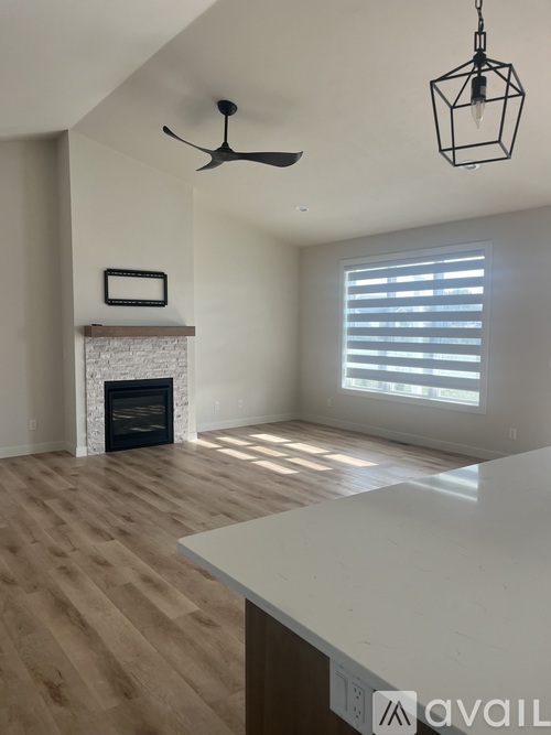 A room with a fireplace and a ceiling fan.