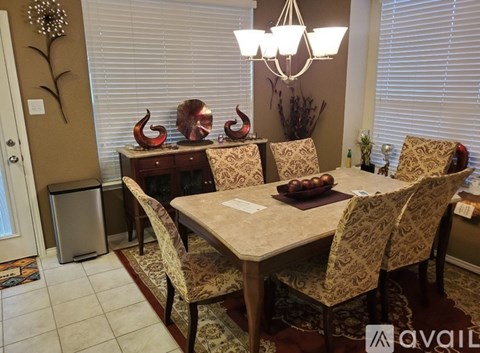 A dining room with a table set for four.