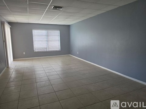 A room with grey walls and a tiled floor.