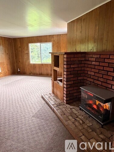 A room with a fireplace and a window.