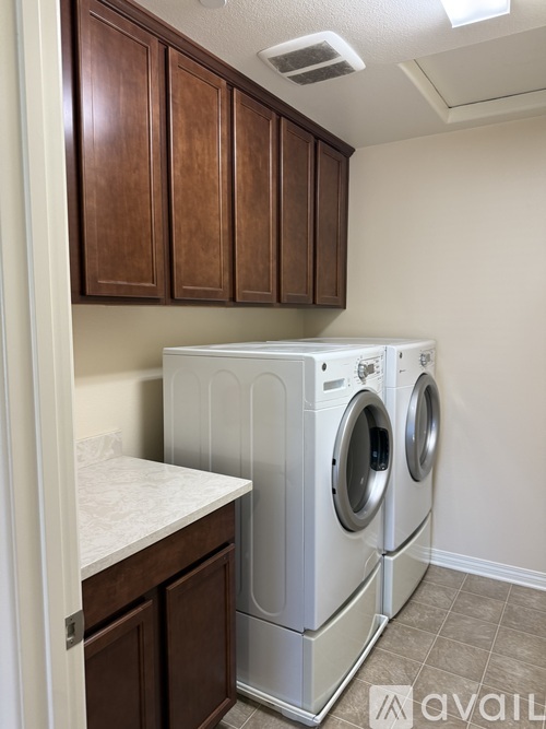 A washer and dryer in a small laundry room.