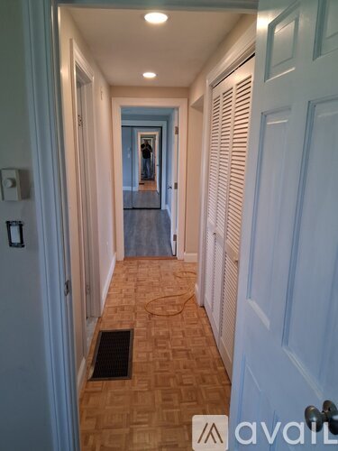 A hallway with a person standing in the distance.