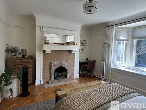 A living room with a fireplace and a chair.