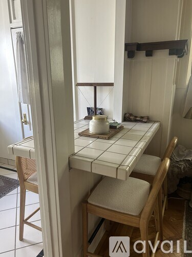 A kitchen with a table and chairs.