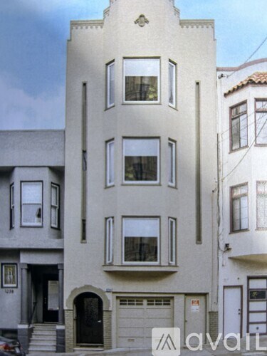 A tall building with a garage door on the ground floor.