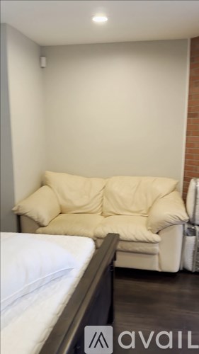 A bedroom with a bed and a couch.