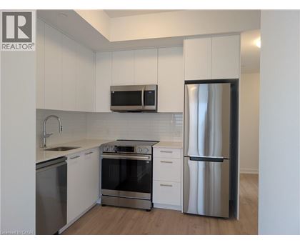 A kitchen with white cabinets and stainless steel appliances.