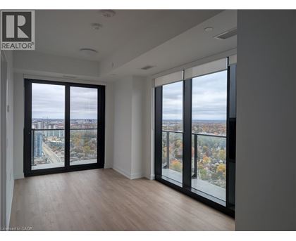 A room with a view of the city through large windows.