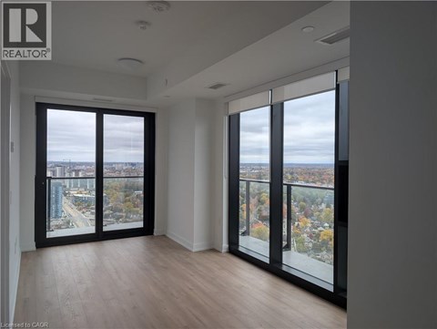 A room with a view of the city through large windows.