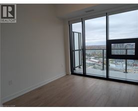 A room with a view of the city through large windows.
