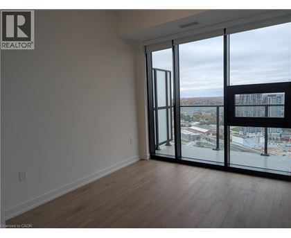 A room with a view of the city through large windows.