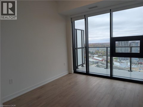 A room with a view of the city through large windows.