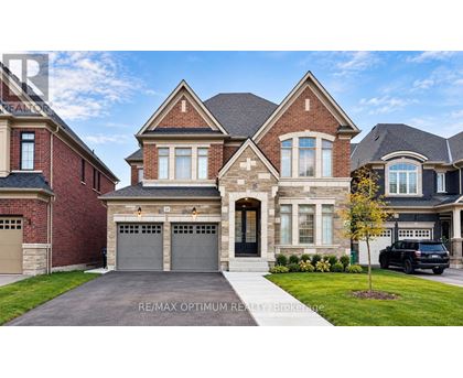 A large, two-story house with a garage is for sale.
