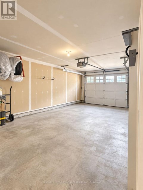 A spacious garage with a concrete floor and white walls.