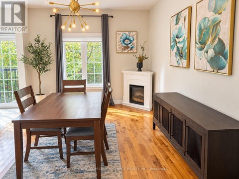 A dining room with a wooden table and chairs.