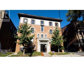 A brick building with a white door and windows.