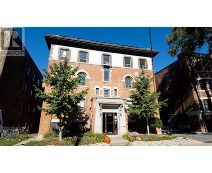 A brick building with a white door and windows.