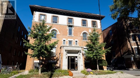 A brick building with a white door and windows.