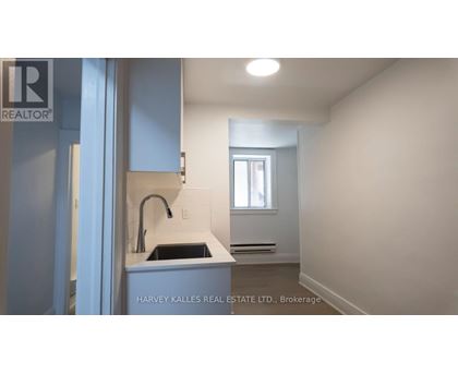 A kitchen area with a sink and a window.