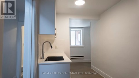 A kitchen area with a sink and a window.