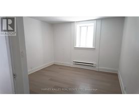 A room with a window and a radiator on the wall.
