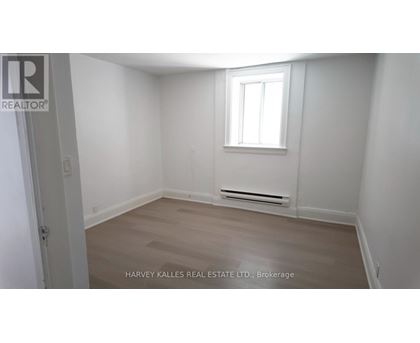 A room with a window and a radiator on the wall.