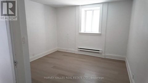 A room with a window and a radiator on the wall.
