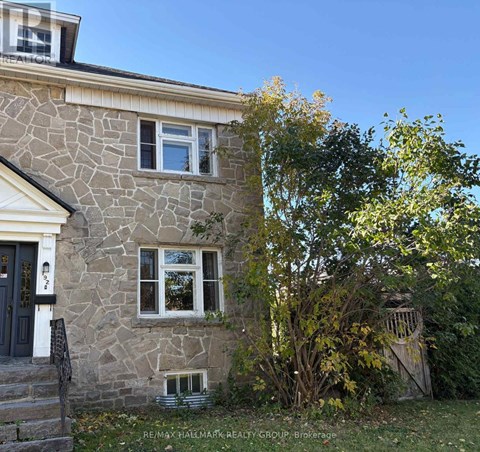 A stone house with a black door and a small window.