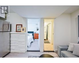 A bedroom with a bed and a couch in it.
