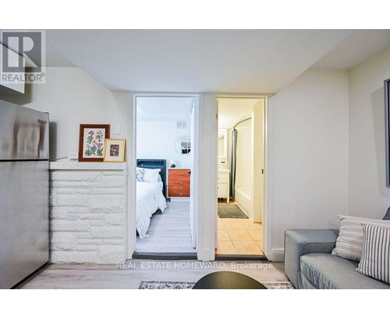 A bedroom with a bed and a couch in it.