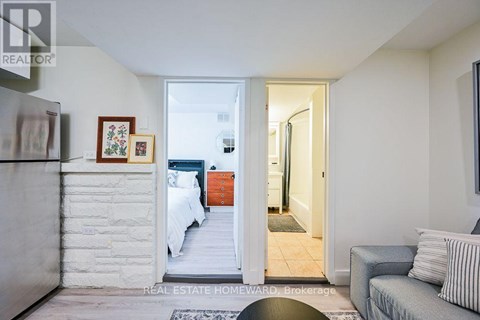 A bedroom with a bed and a couch in it.
