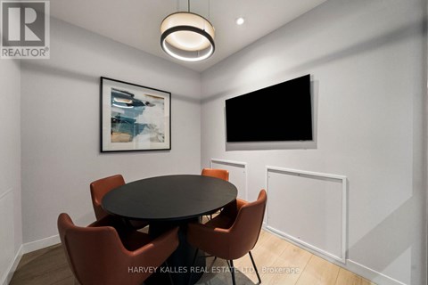 A dining room with a table and chairs.