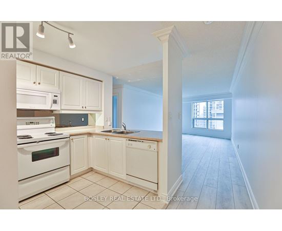 A kitchen with white appliances and cabinets is on the market with Bosley Real Estate LTD.