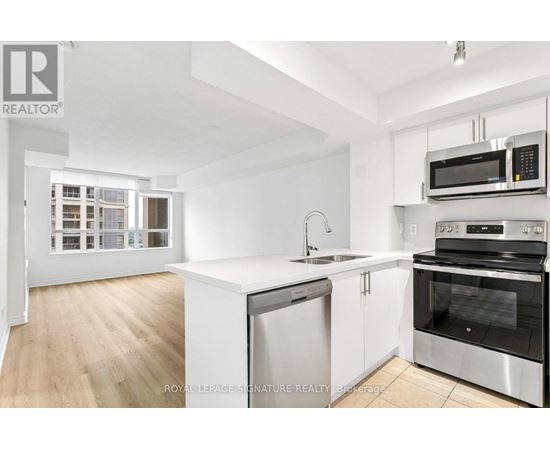 A white kitchen with a sink and stove.