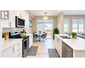 A kitchen with white cabinets and a black stove top oven.