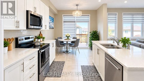 A kitchen with white cabinets and a black stove top oven.