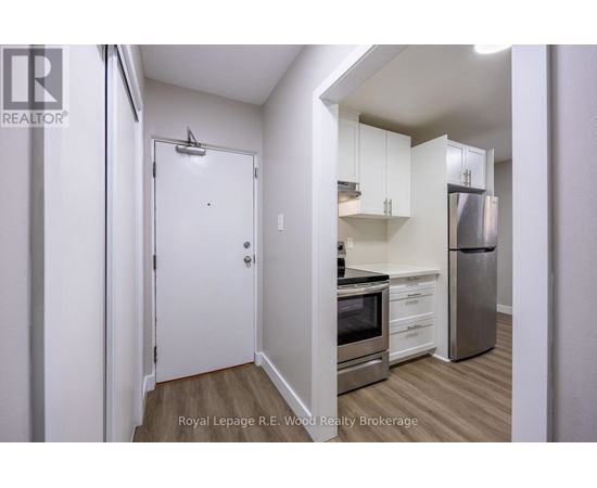 A small kitchen with a refrigerator, oven, and microwave.