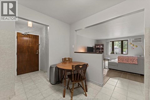 A dining area with a wooden table and chairs.