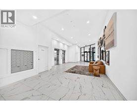 A spacious hallway with marble flooring and a rug.