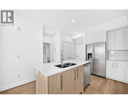 A modern kitchen with wooden cabinets and stainless steel appliances.