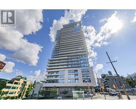 A tall building with many windows is the main focus of the image.