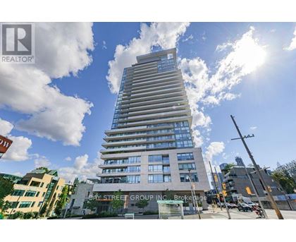 A tall building with many windows is the main focus of the image.