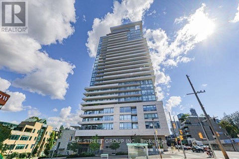 A tall building with many windows is the main focus of the image.