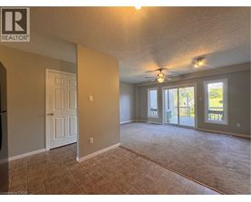 A spacious room with a ceiling fan and sliding glass doors leading to a deck.
